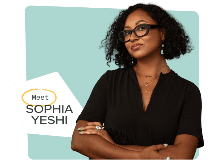 Artist Sophia Yeshi smiling, wearing a black dress and gold necklaces